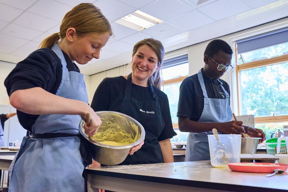 students with their teacher in food tech lesson