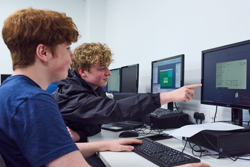 sixth form students working at a computer