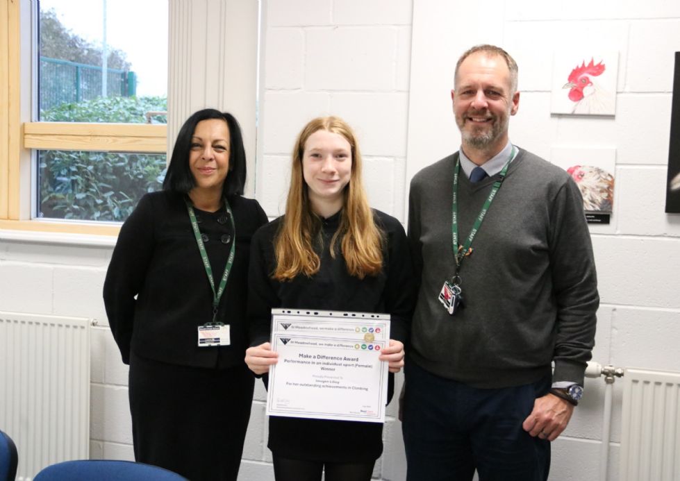 photo of student with award certificate