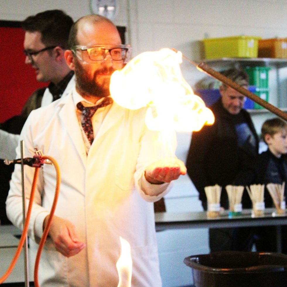 an image of  science teacher doing experiment