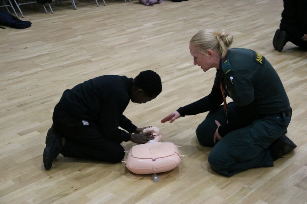 y7 student practices CPR on a model