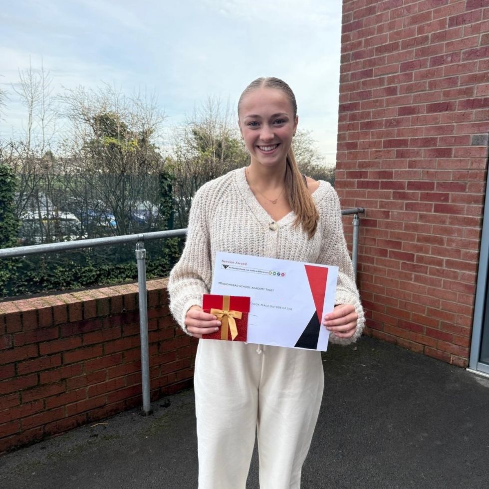 student with her service award