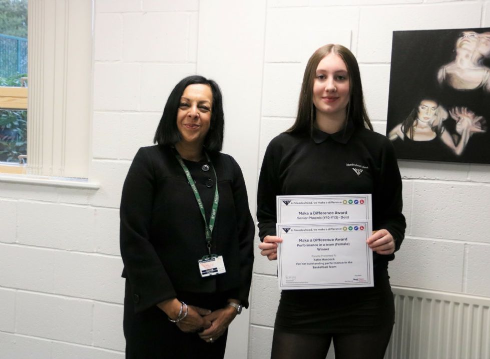 photo of student with award certificate