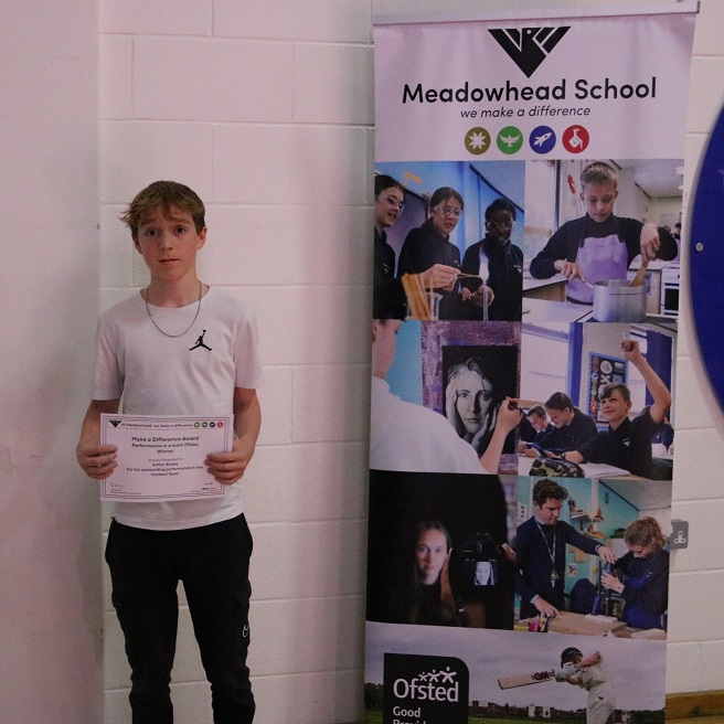 photo of student with award certificate