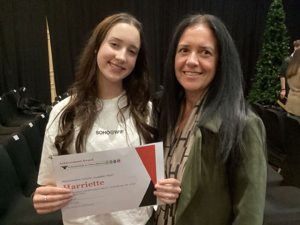 student and parent with certificate