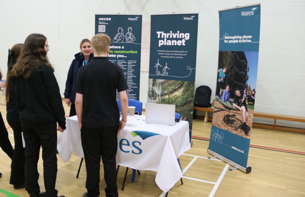 students talk to a stall holder at the fair