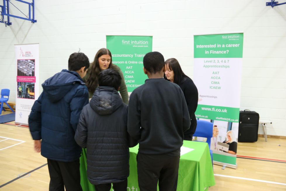 students talk to a stall holder at the fair