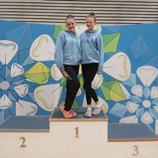 students on the podium at a trampolining competition