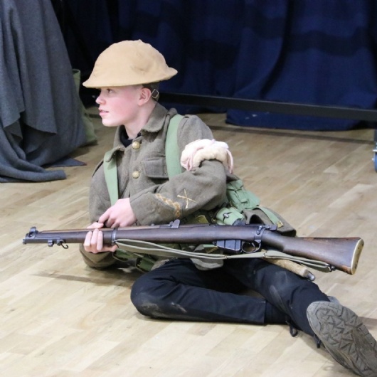 student dressed as a WW1 soldier in need of first aid