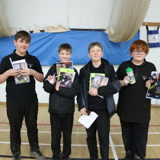 students in year 7 showing off the leaflets they have been given at the futures fair